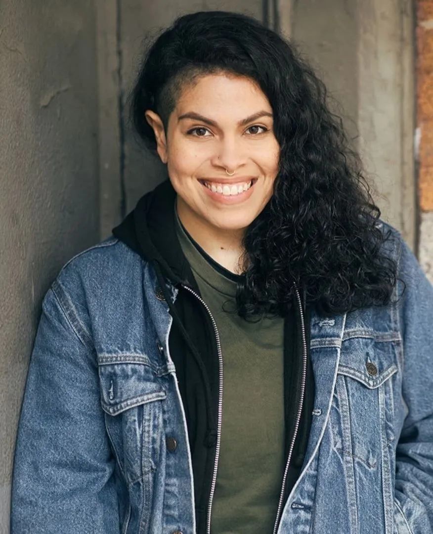 SASHALYN MEDINA smiling in a denim jacket over an olive shirt
