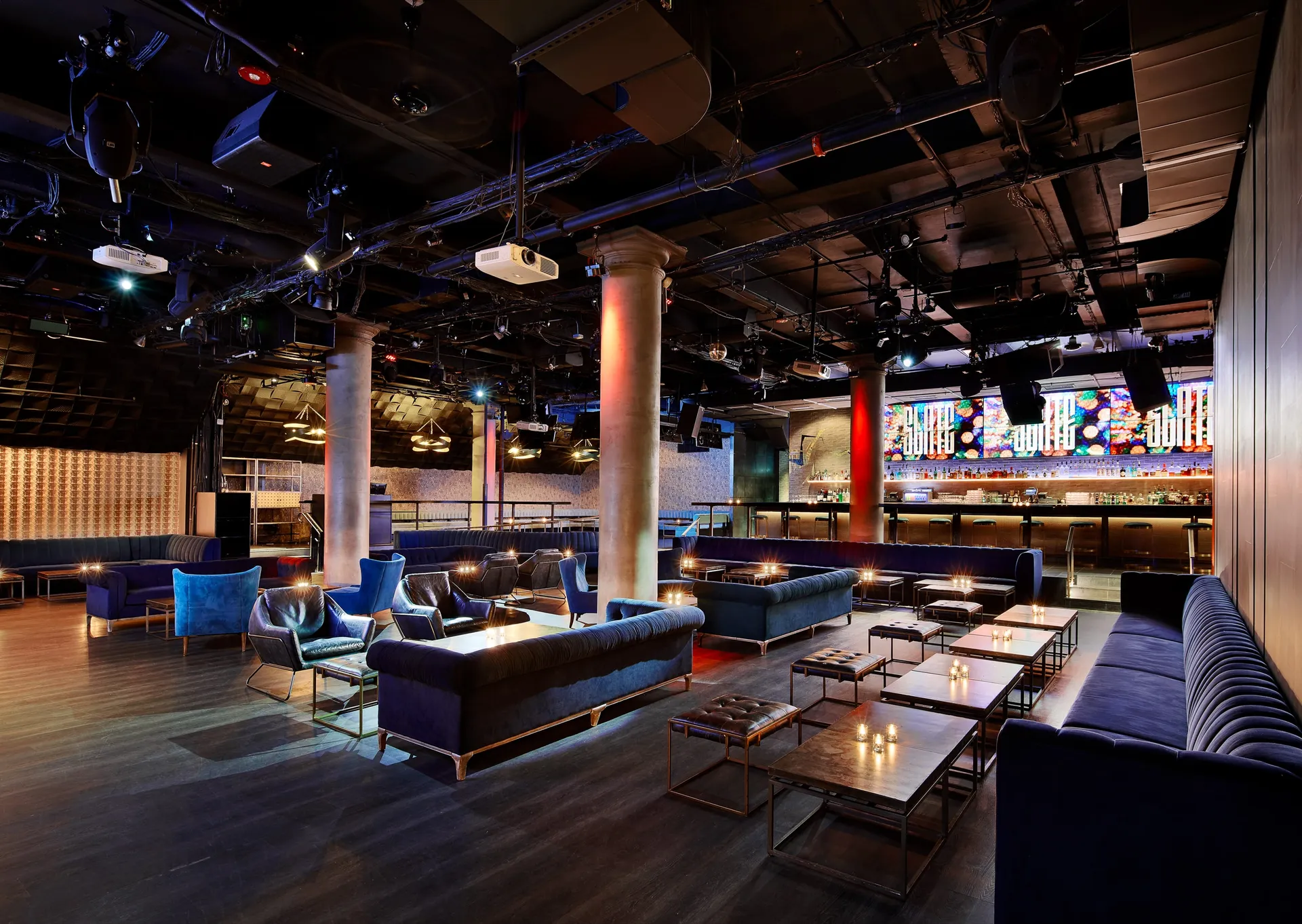 Slate NYC multi-level room with lounge seating and a bar